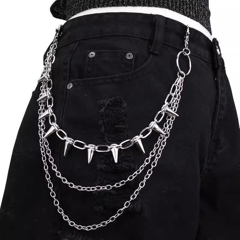 Silver double-layer pant chain with rivet accents and zipper details on dark trousers