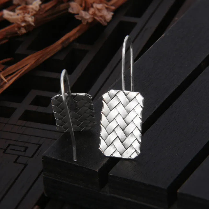 Silver geometric earrings with woven diamond plaid pattern measuring 17.5mm by 11mm