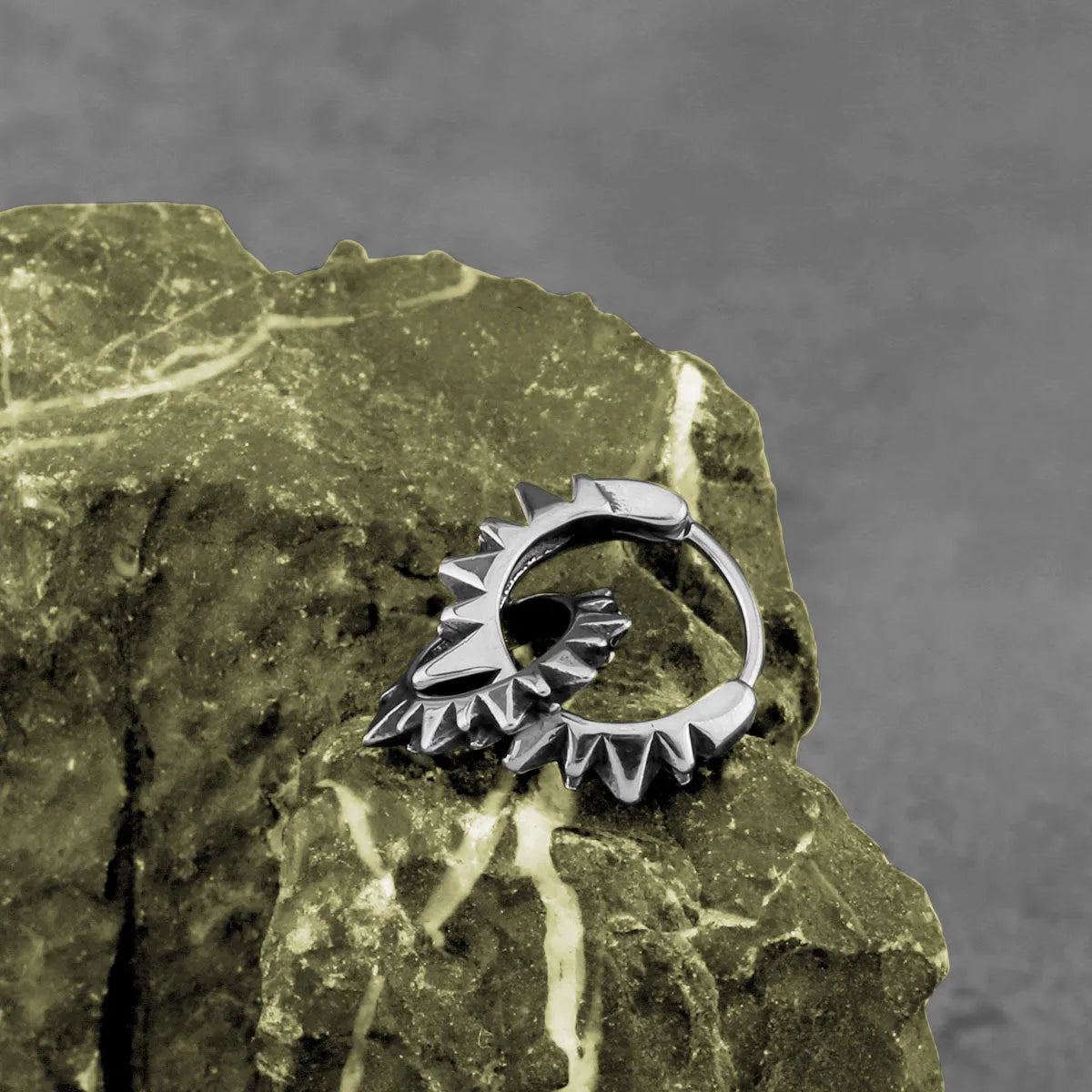 Stainless steel retro round ring earrings with polished steel finish on model
