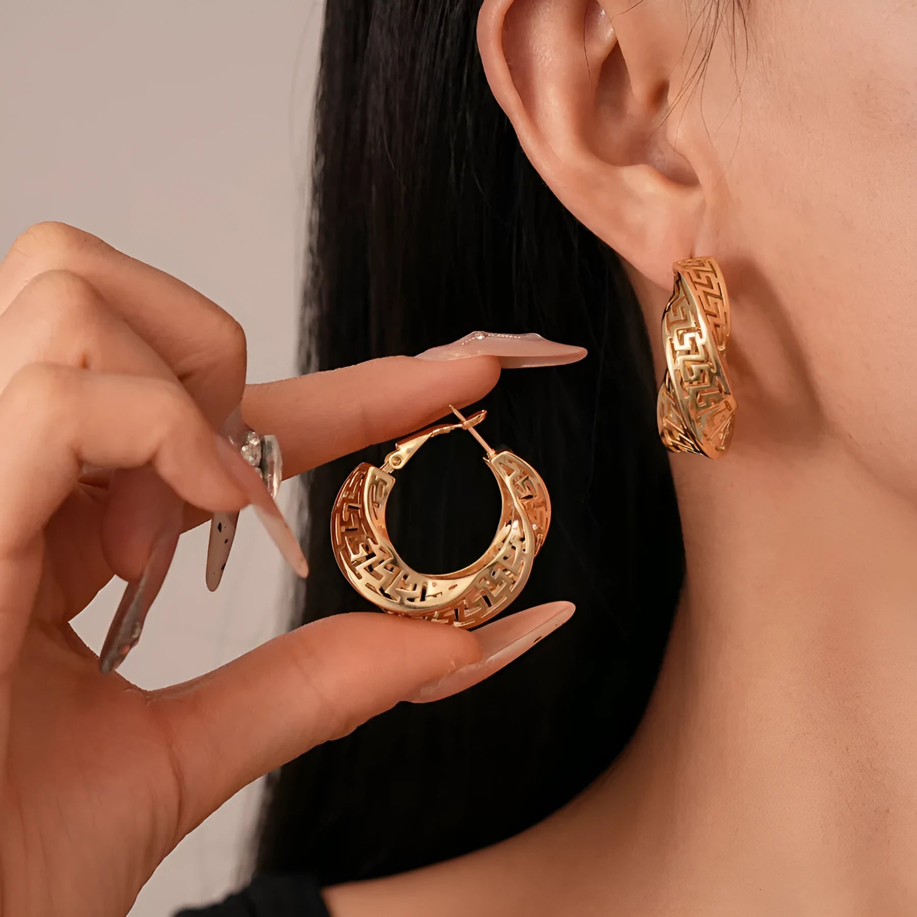 Women's geometric hollow stud earrings with exaggerated twisted round shape and electroplated silver finish