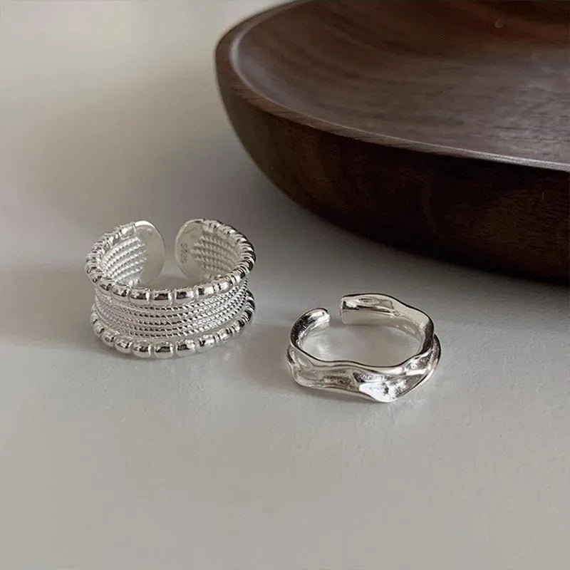 Adjustable opening copper alloy ring with geometric shape and woven twisted multilayer design