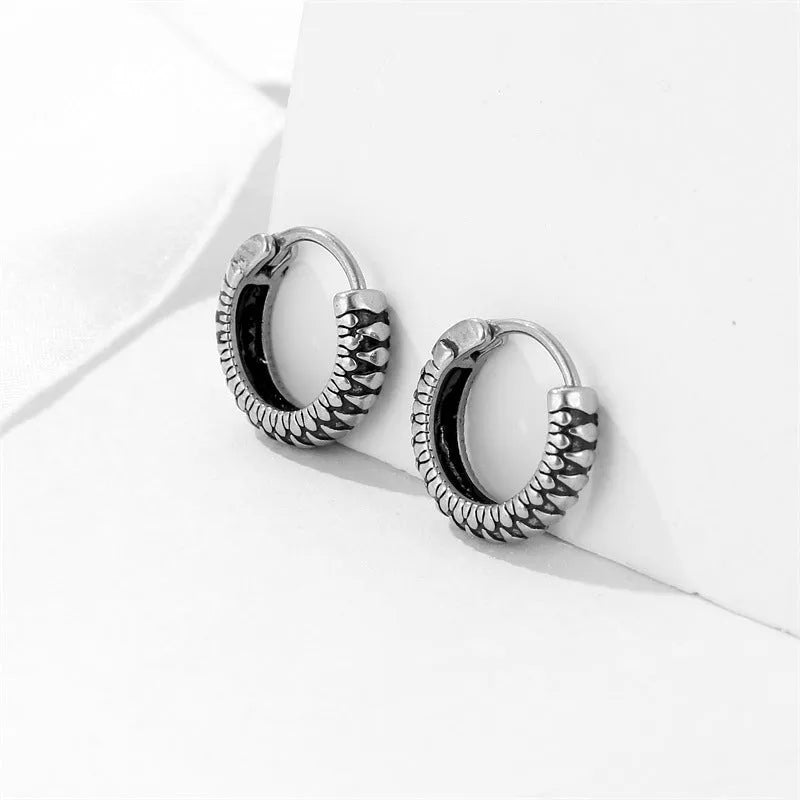 Silver geometric striped earrings with a circular centre, made from polished stainless steel.