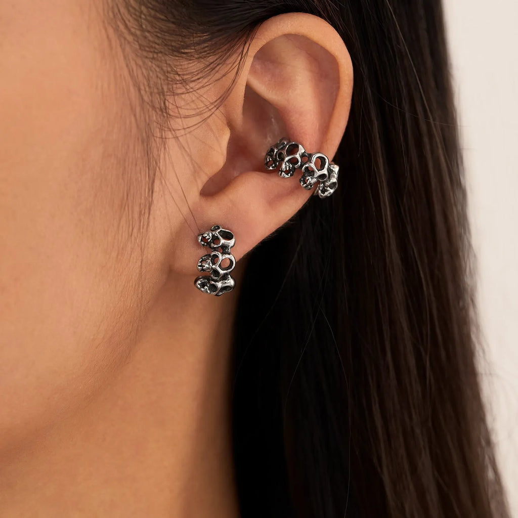Stainless steel hollow skull earrings with electroplated finish and geometric design