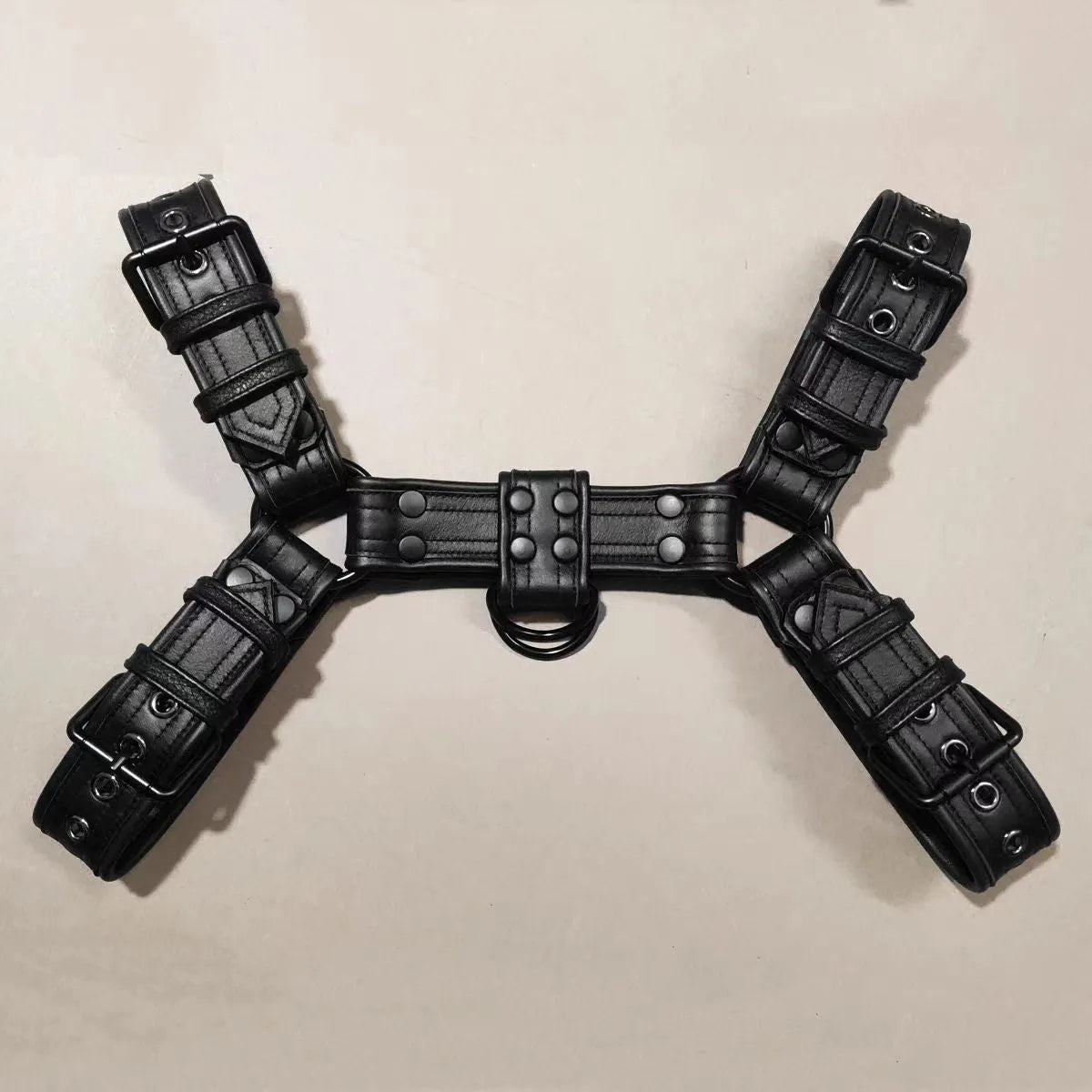 Black leather men's chest strap with metal adjustment buckle and rivets