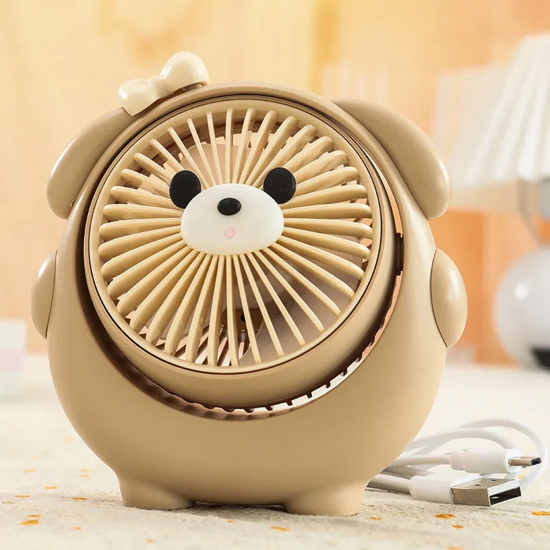 Dog-themed plastic USB desktop fan in Apricot Puppy colour on a wooden desk.
