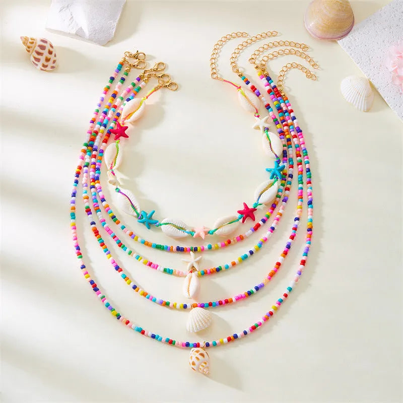 Women's multi-layer necklace set with starfish and shell pendants in blue and assorted colours