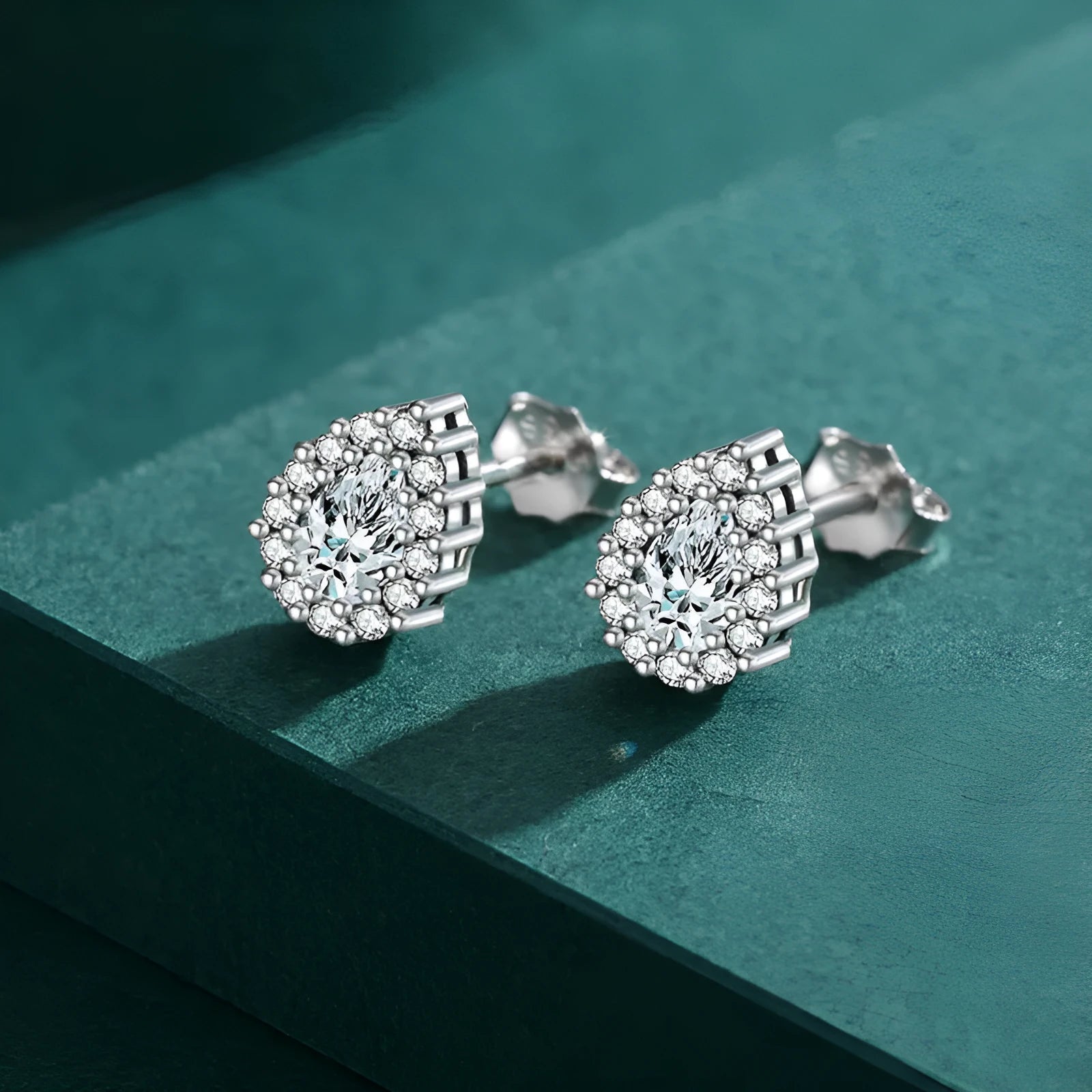 Silver water drop ear studs with geometric shape and diamond-cut surface