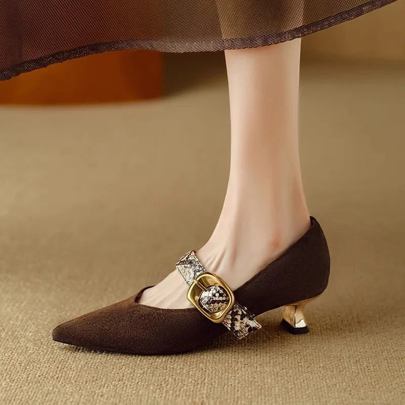Women's black pointed toe stiletto heels with a buckle fastening and a low-cut design.