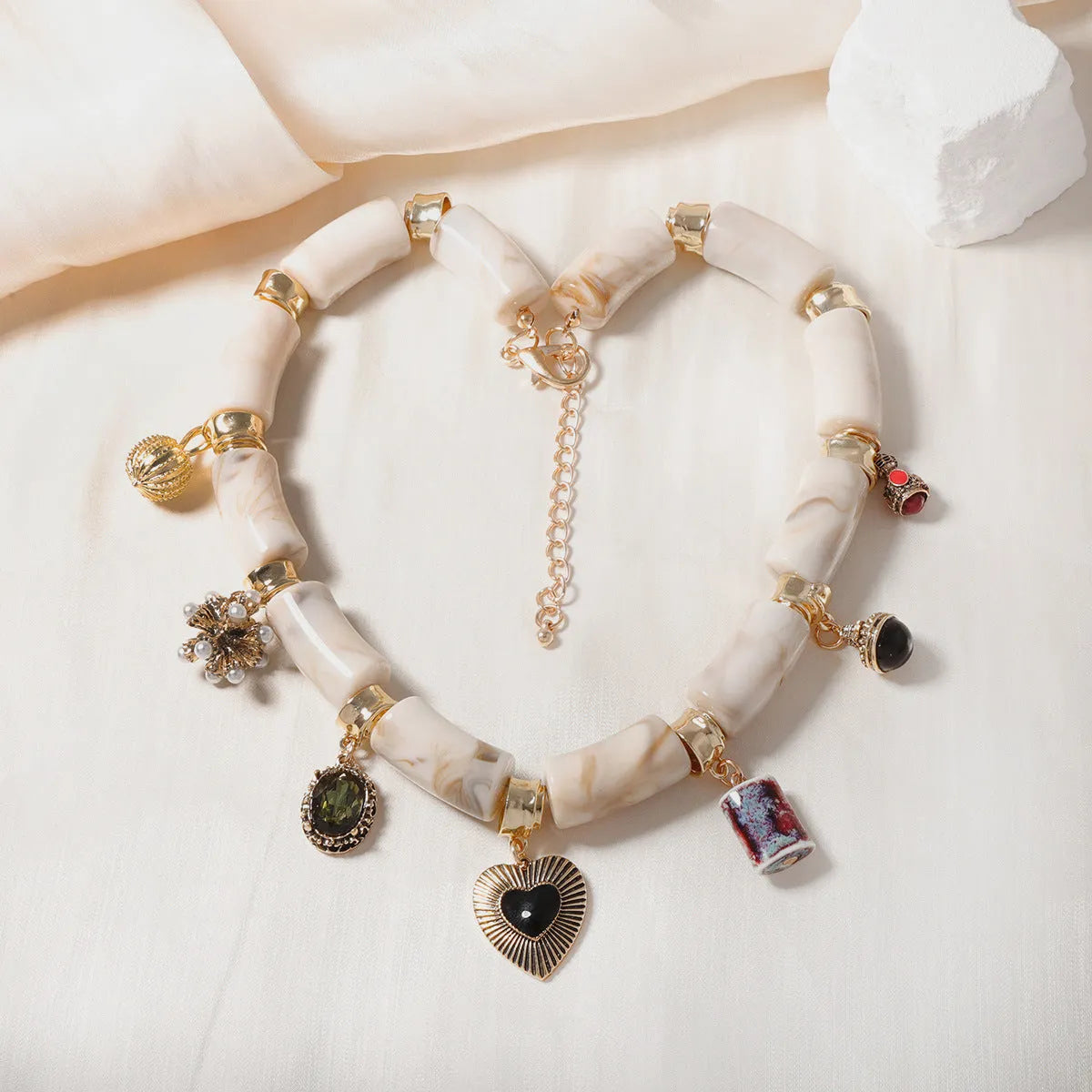 Electroplated resin bamboo heart pendant necklace with chain on white background