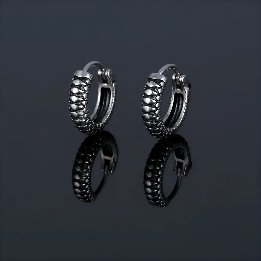 Silver geometric striped earrings with a circular centre, made from polished stainless steel.