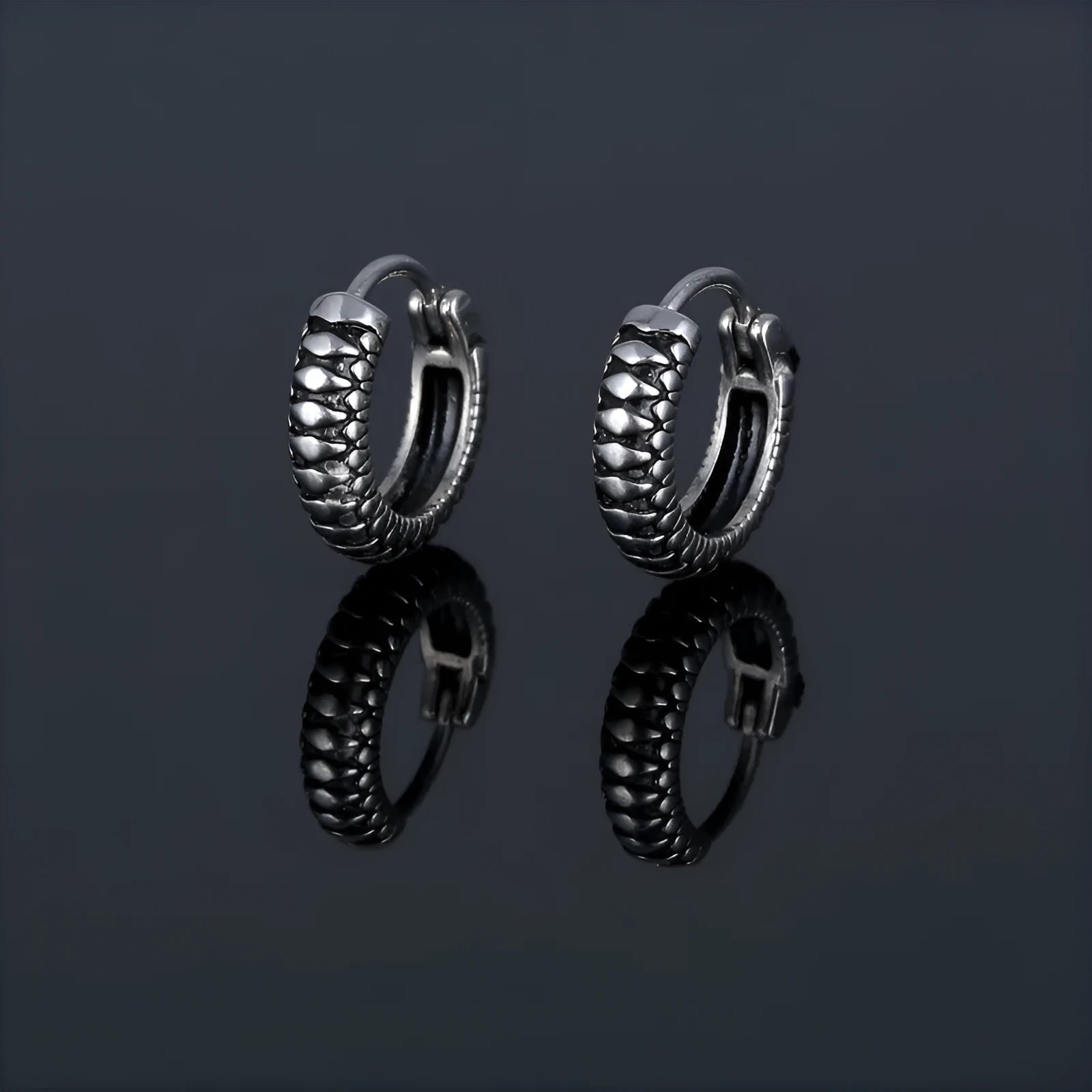 Silver geometric striped earrings with a circular centre, made from polished stainless steel.