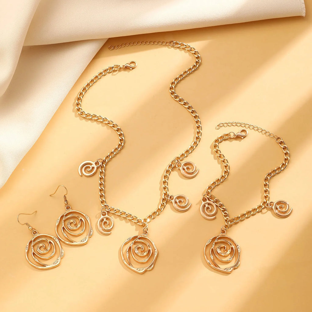 Spiral donut jewellery set with necklace, bracelet and earrings showing geometric circle designs in gold and silver finishes