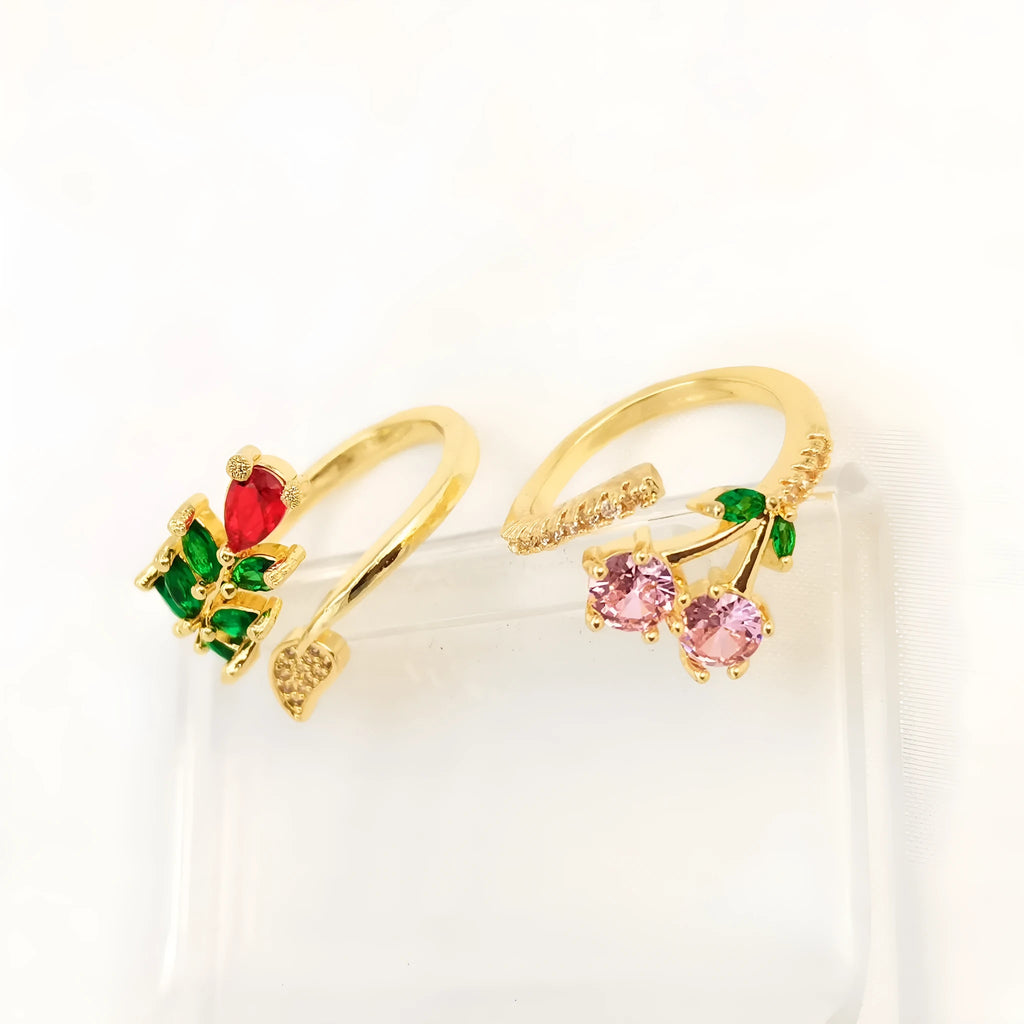 Copper open ring with a geometric gold zircon leaf design on a model's hand.