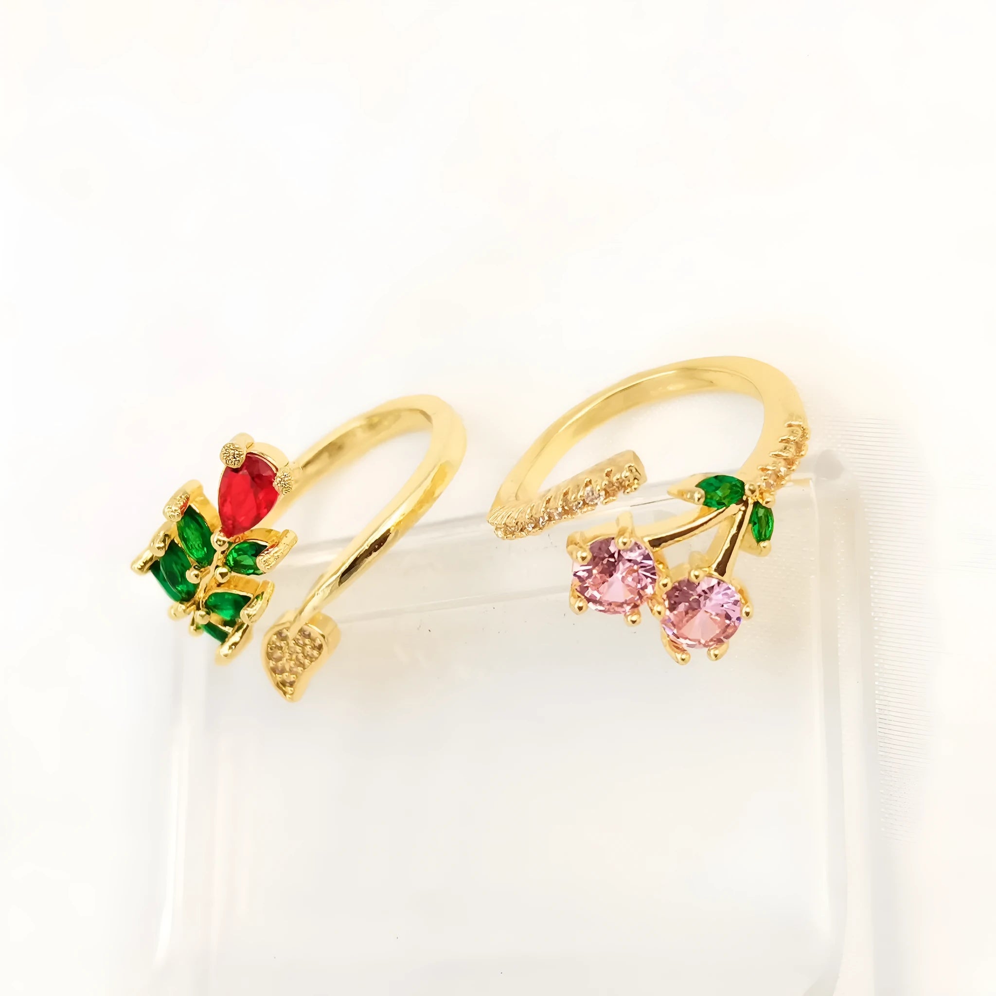 Copper open ring with a geometric gold zircon leaf design on a model's hand.