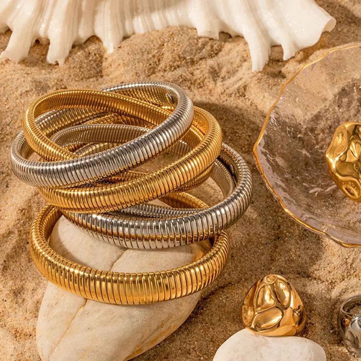 Women's titanium steel elastic bracelet showing vertical stripe ring pattern in gold finish