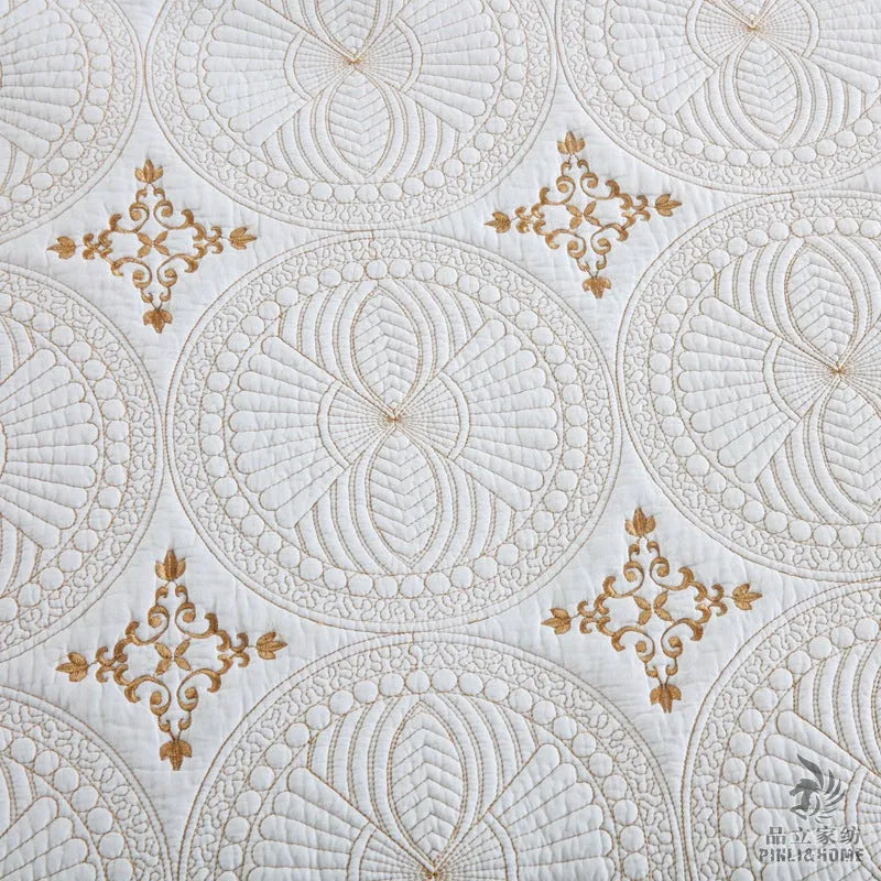 European style embroidered pure cotton bed cover set with two pillowcases on a bed