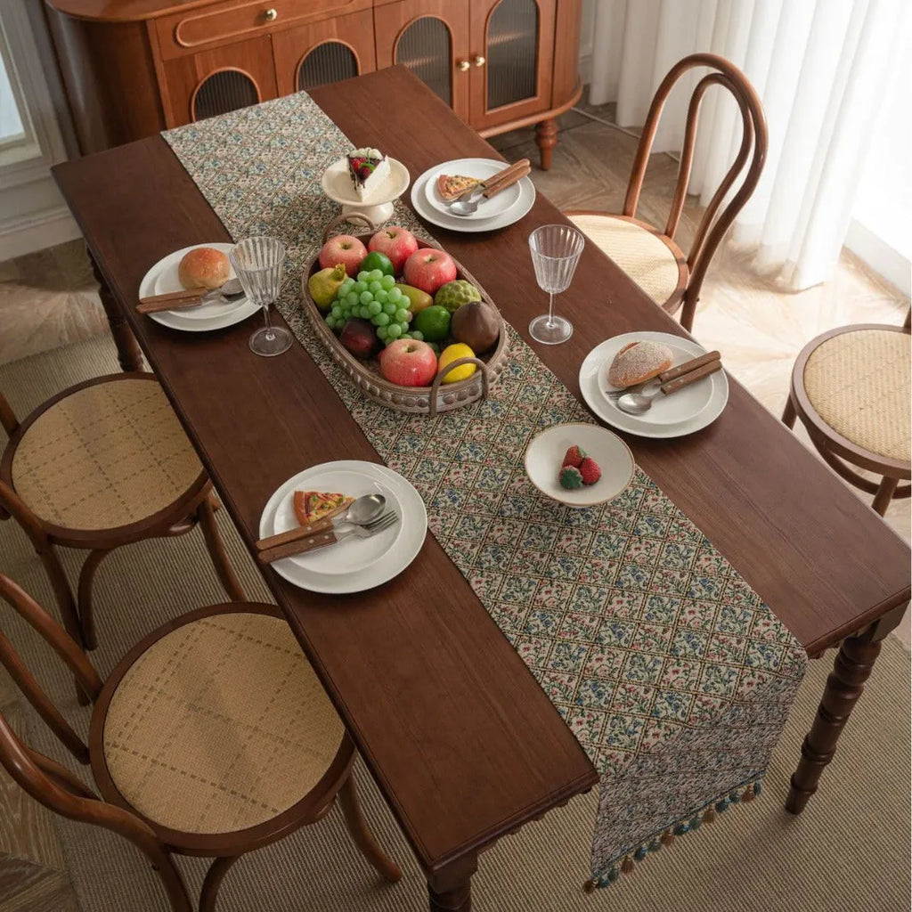 Nordic jacquard table runner with tassel trim in dark blue stripe pattern on wooden table