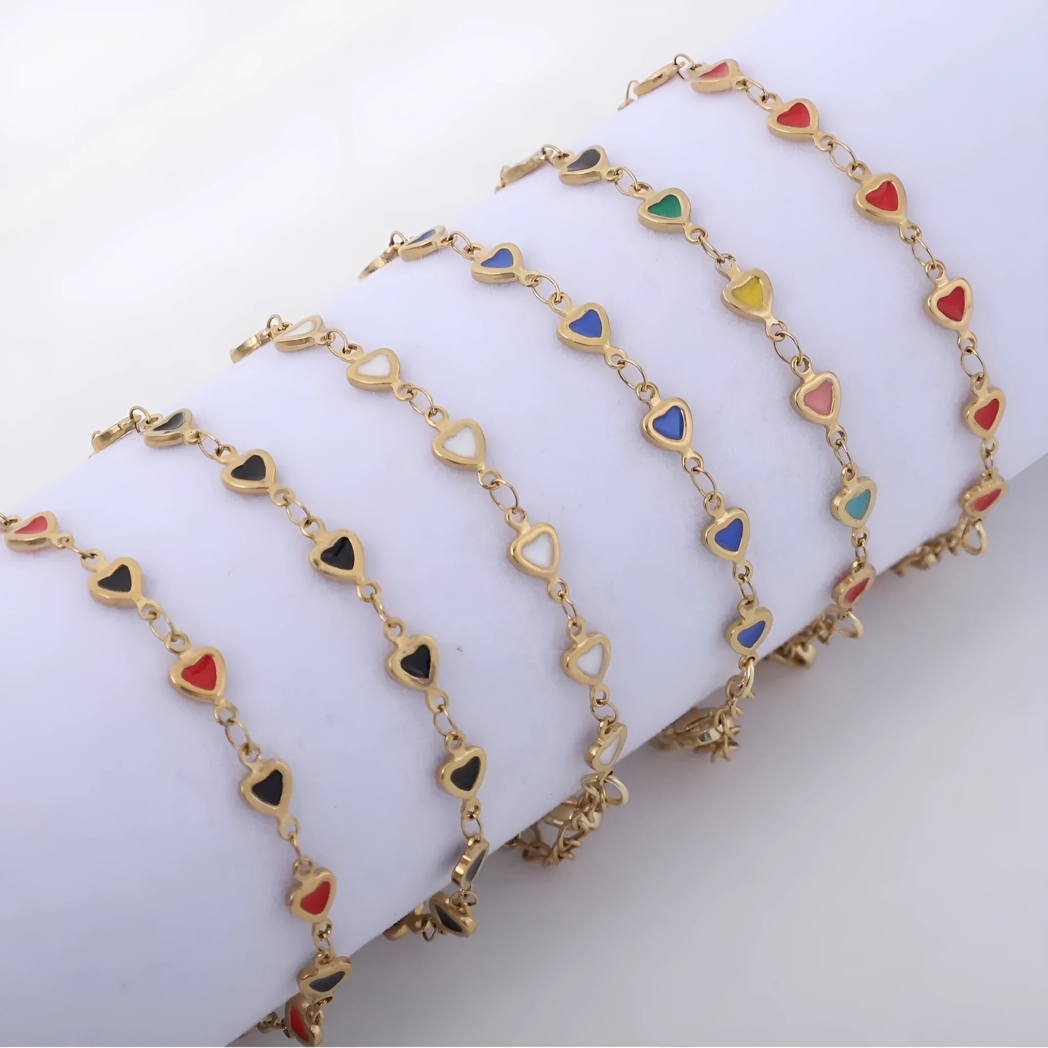 Stainless steel heart-shaped bracelet with 18K gold plating on an adjustable link strap.