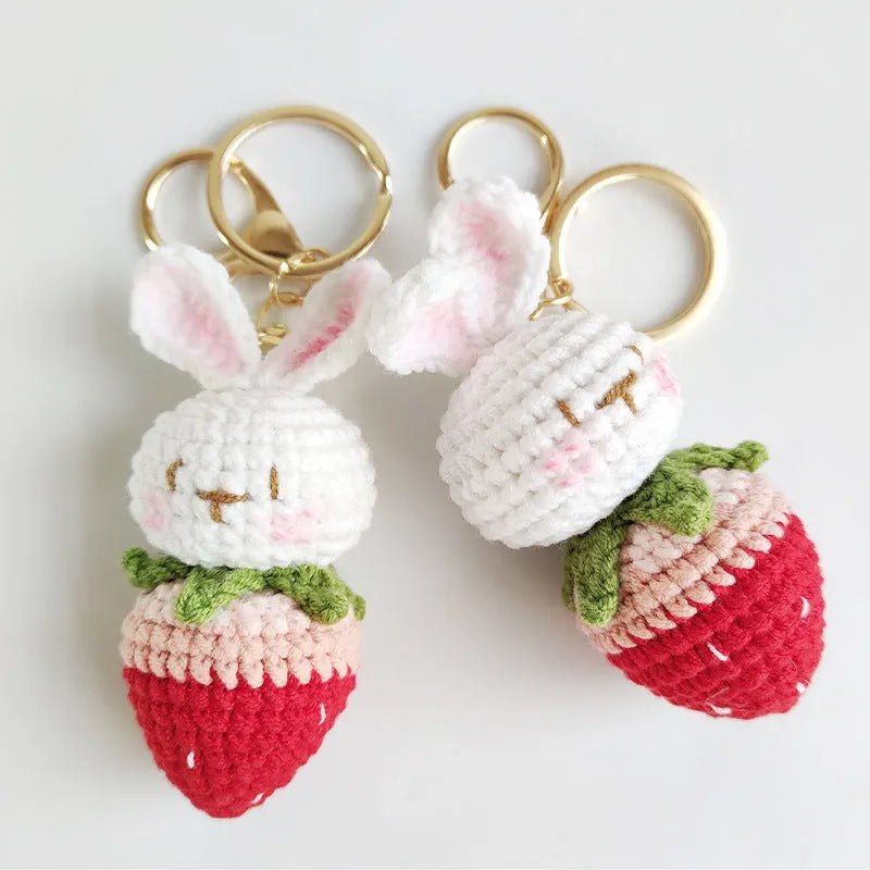 Hand-woven white wire rabbit pendant with strawberry design and key attachment
