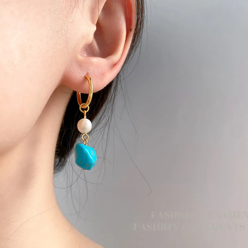 A pair of short and a pair of long turquoise cultured pearl ear clips with geometric copper settings.