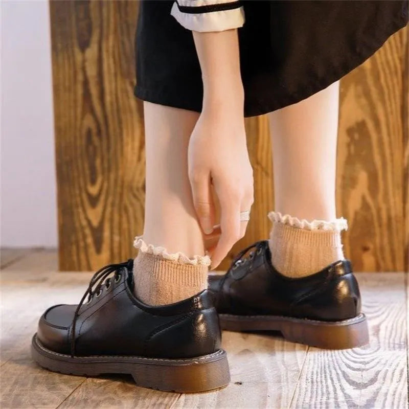 Women's black preppy retro Mary Jane pumps with low square heel and front lace-up.