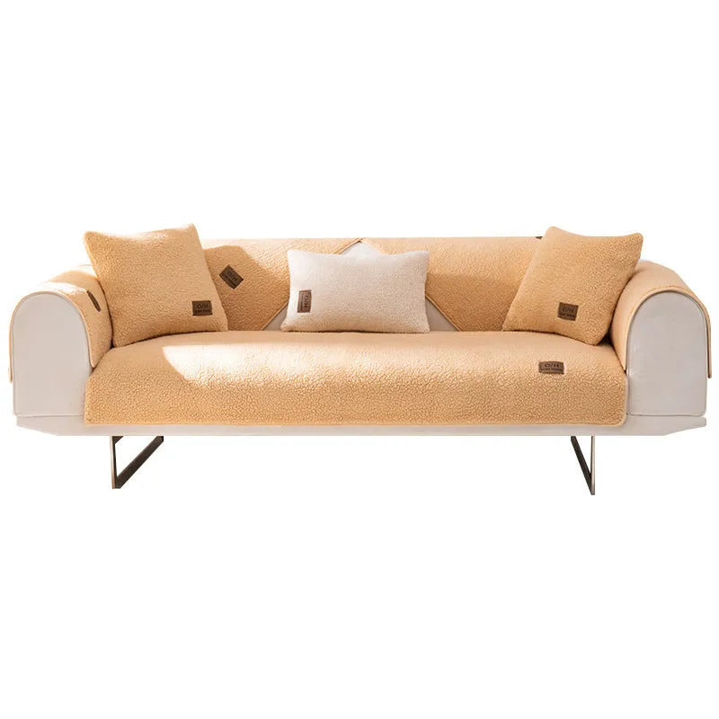 Lambswool sofa slipcover in a solid blue colour, shown on a sofa.
