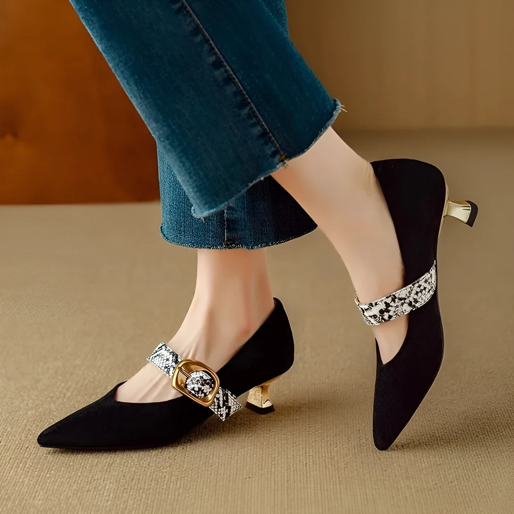 Women's black pointed toe stiletto heels with a buckle fastening and a low-cut design.