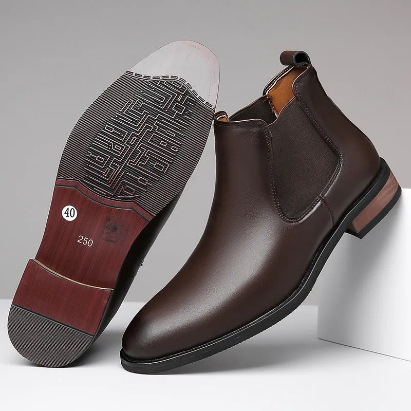 Men's black Chelsea boots with pointed toe design and decorative stitching