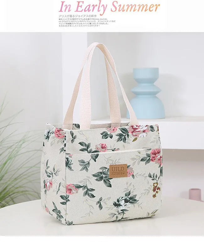 Women's printed canvas square handbag in a floral design, showing large capacity and structured shape.