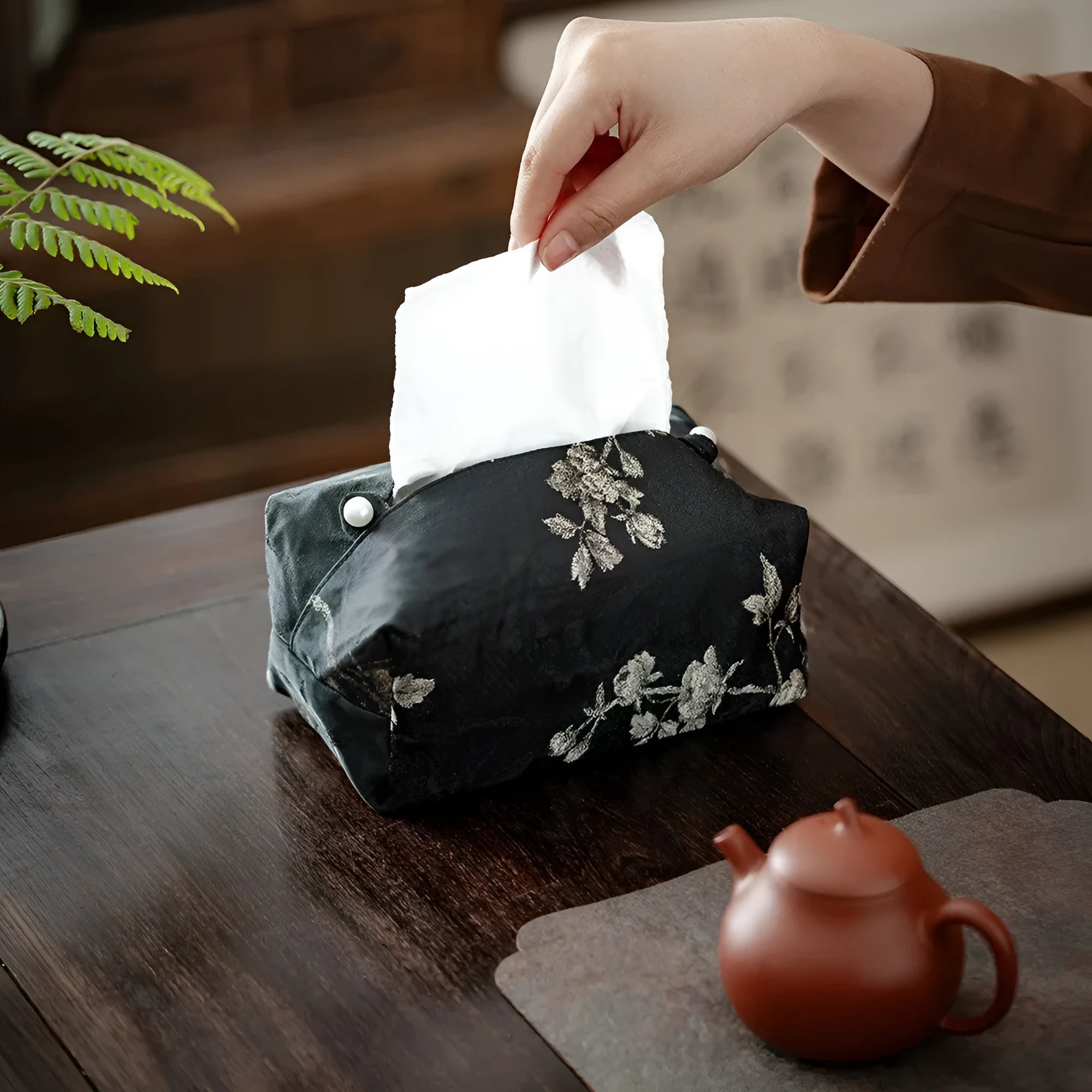 Chinese brocade fabric tissue box cover with embroidered white plum pattern, shown with and without a pearl buckle clasp