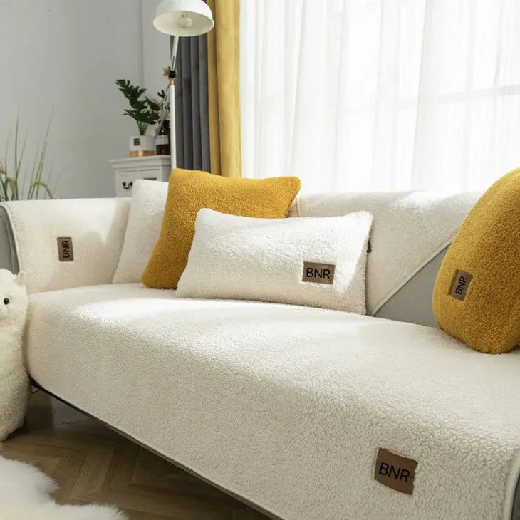 Lambswool sofa slipcover in a solid blue colour, shown on a sofa.