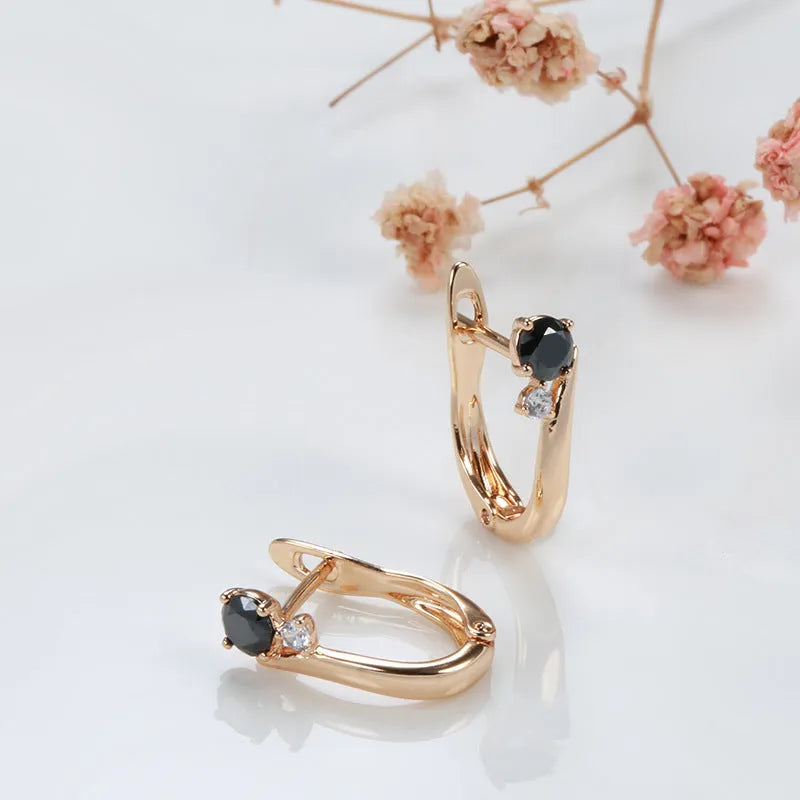 Women's gold geometric drop earrings with black agate stone effect and retro styling