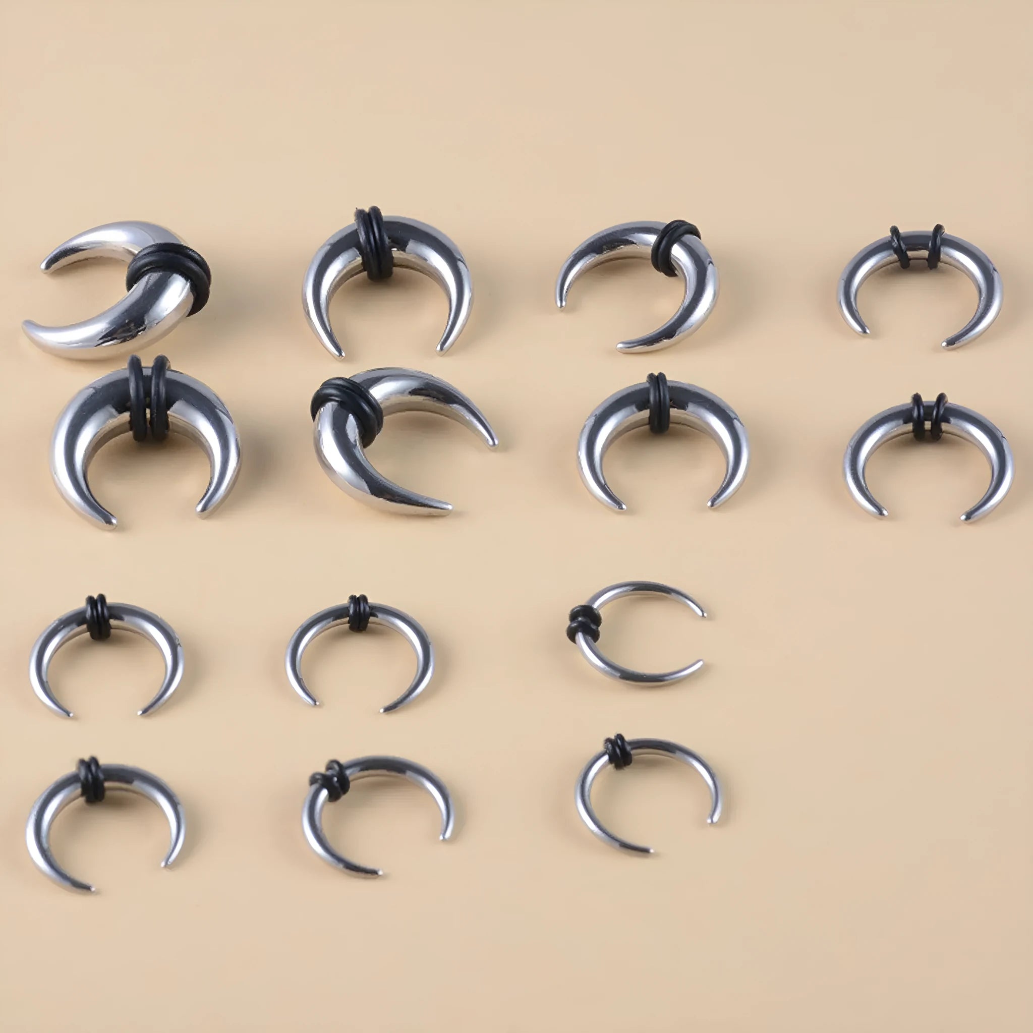 Geometric C-shaped nose ring with buffalo horn inlay, shown in steel colour on a grey background.