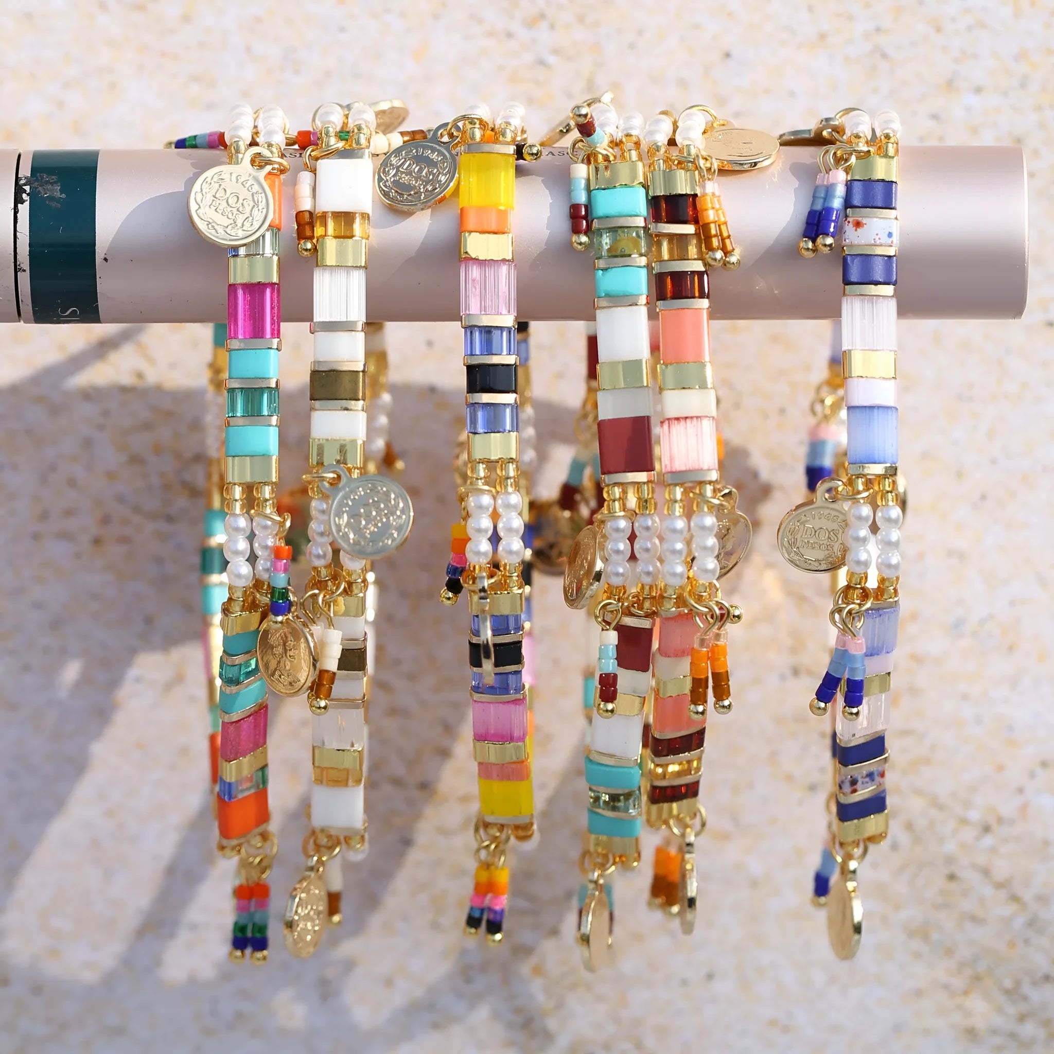 Women's handcrafted imitation pearl bracelet shown in one of six available colour variations.