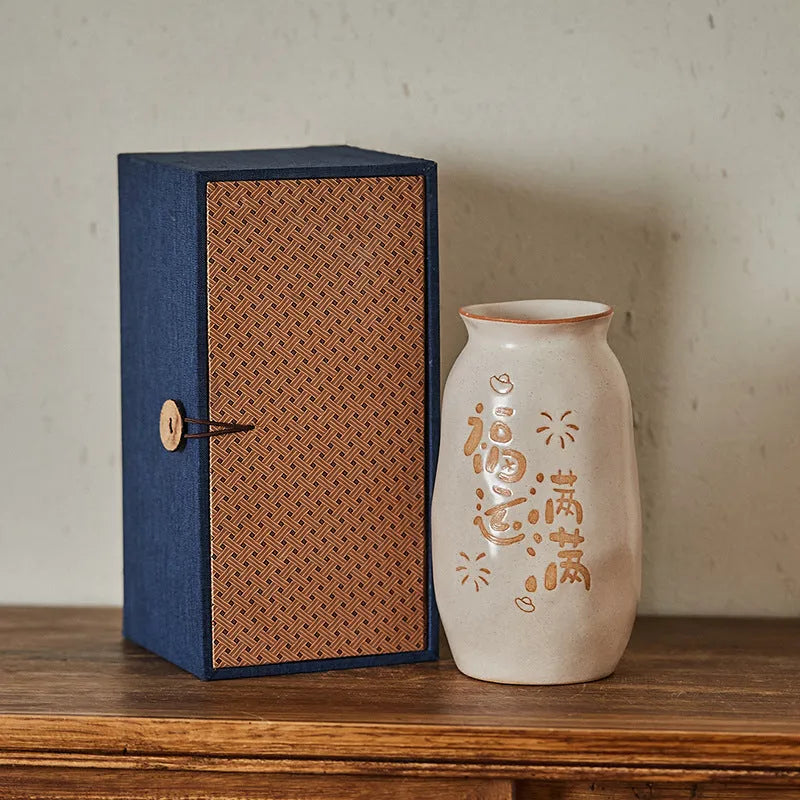 Chinese hand-painted ceramic joy vase with carved detail on desktop