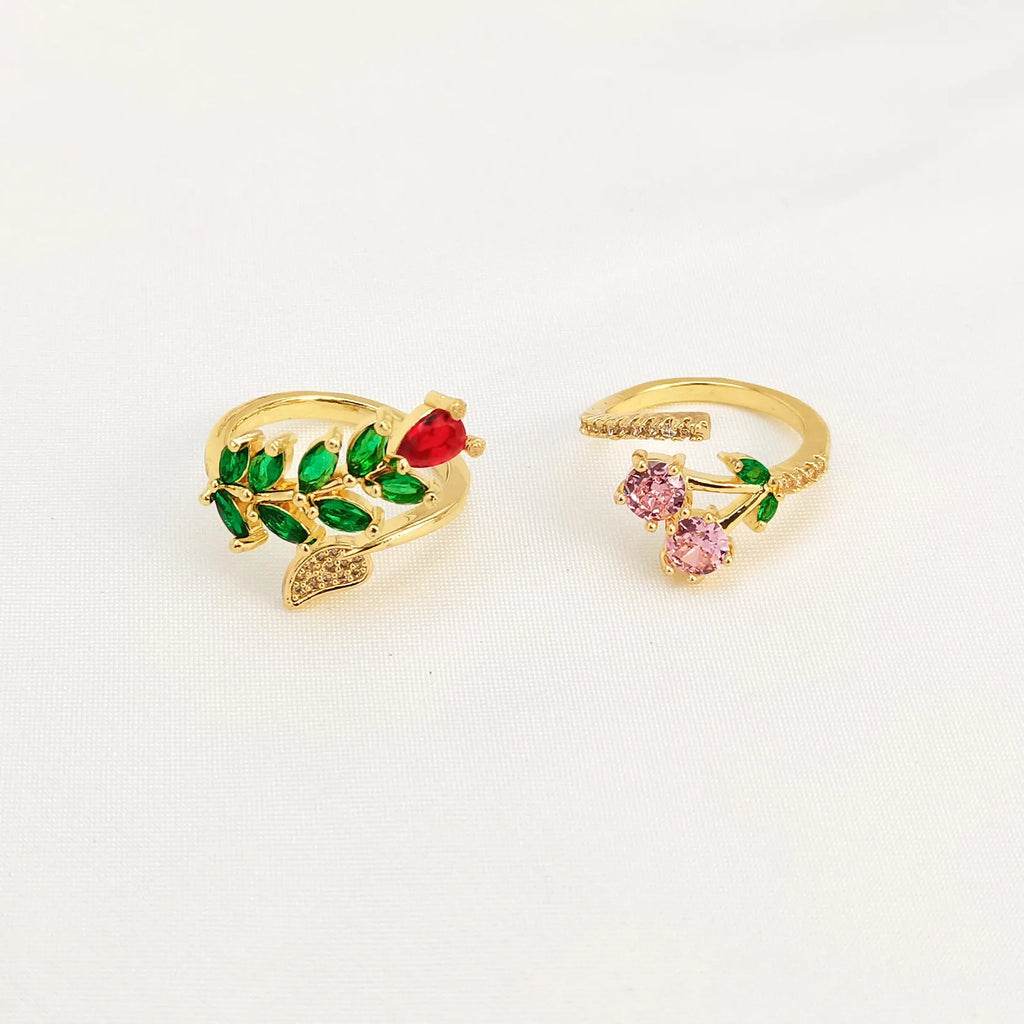 Copper open ring with a geometric gold zircon leaf design on a model's hand.