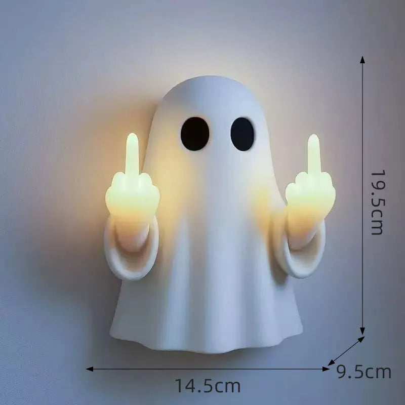 Small white ghost-shaped plastic night lamp for Halloween decoration on a table.