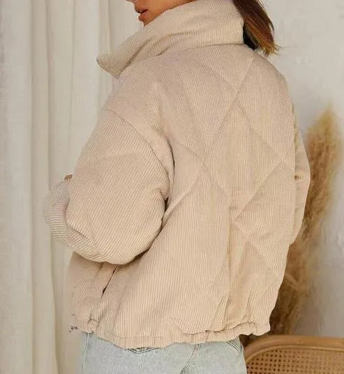 Women's apricot corduroy jacket with stand collar and front zip, showing textured fabric detail