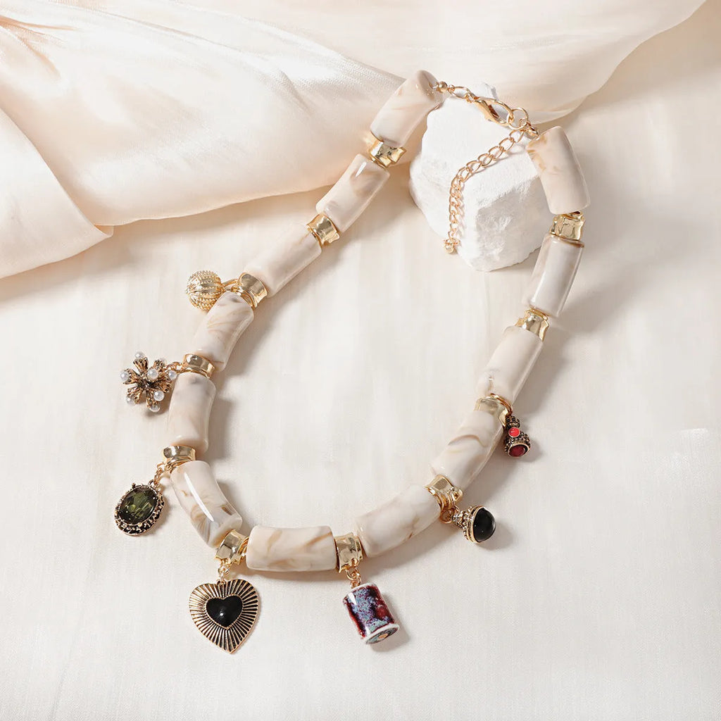 Electroplated resin bamboo heart pendant necklace with chain on white background
