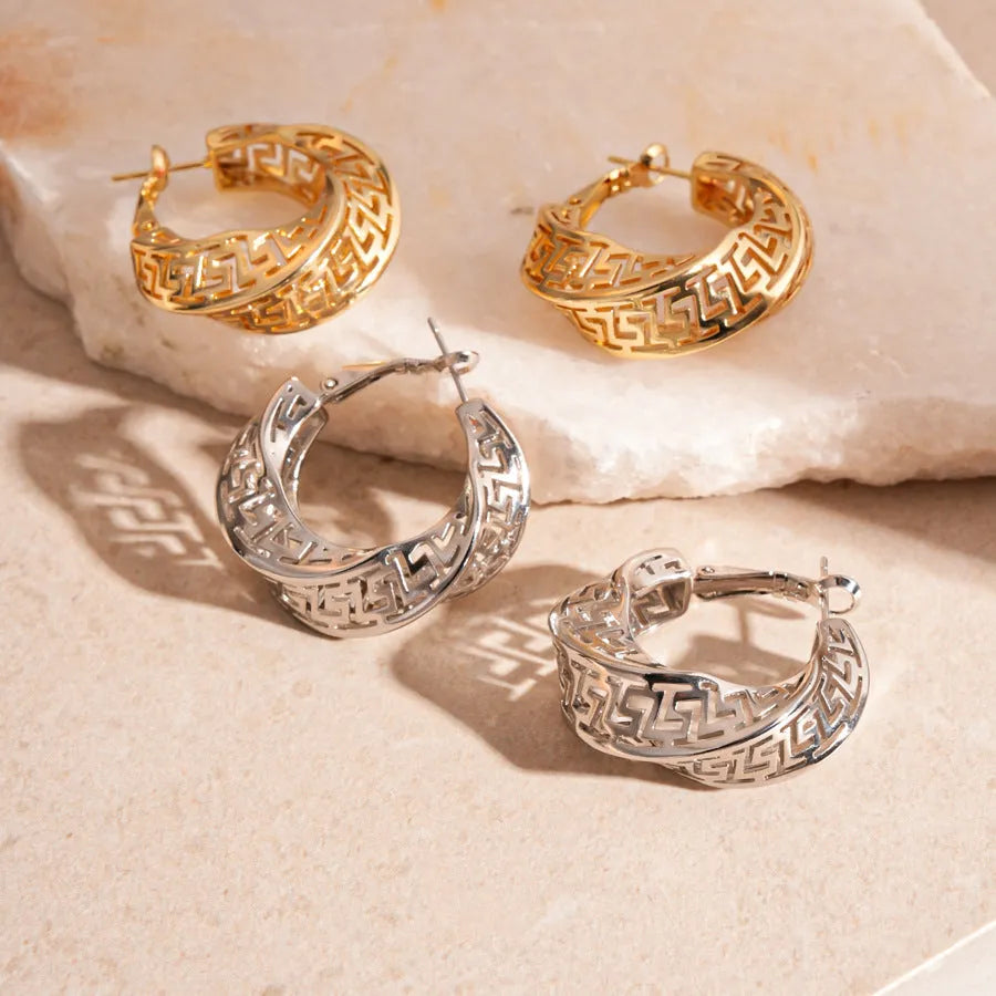 Women's geometric hollow stud earrings with exaggerated twisted round shape and electroplated silver finish