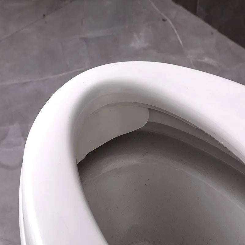 White PVC toilet urine blocking board placed on standard toilet seat