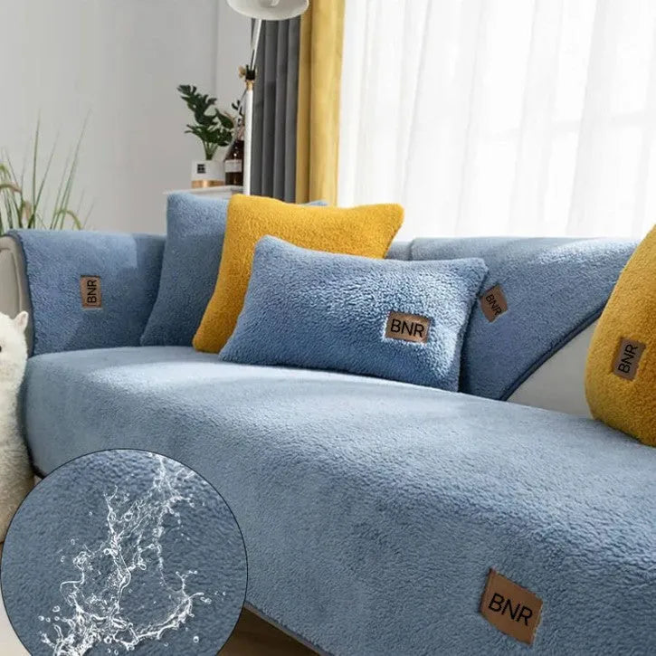 Lambswool sofa slipcover in a solid blue colour, shown on a sofa.