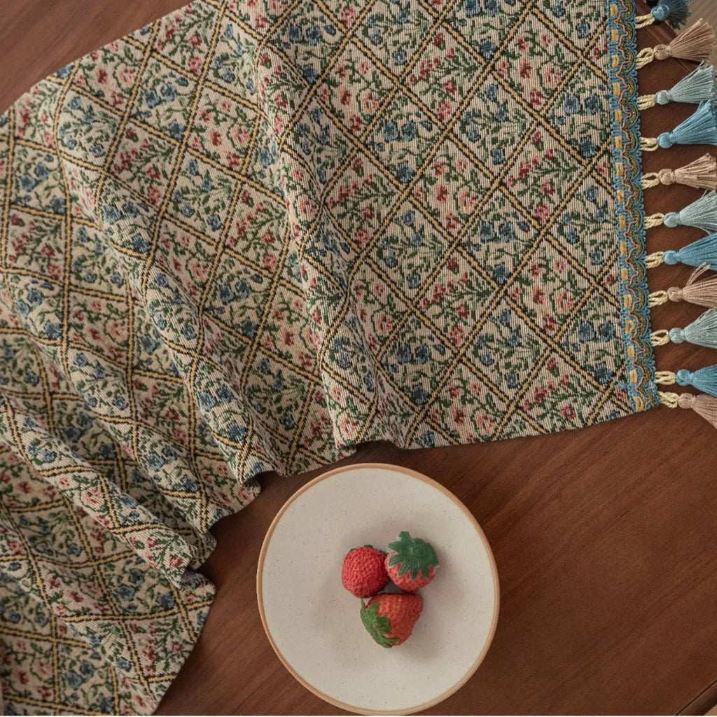 Nordic jacquard table runner with tassel trim in dark blue stripe pattern on wooden table