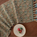 Nordic jacquard table runner with tassel trim in dark blue stripe pattern on wooden table