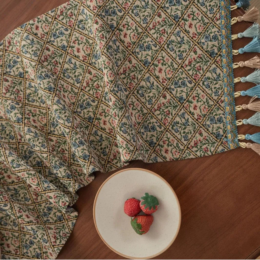 Nordic jacquard table runner with tassel trim in dark blue stripe pattern on wooden table
