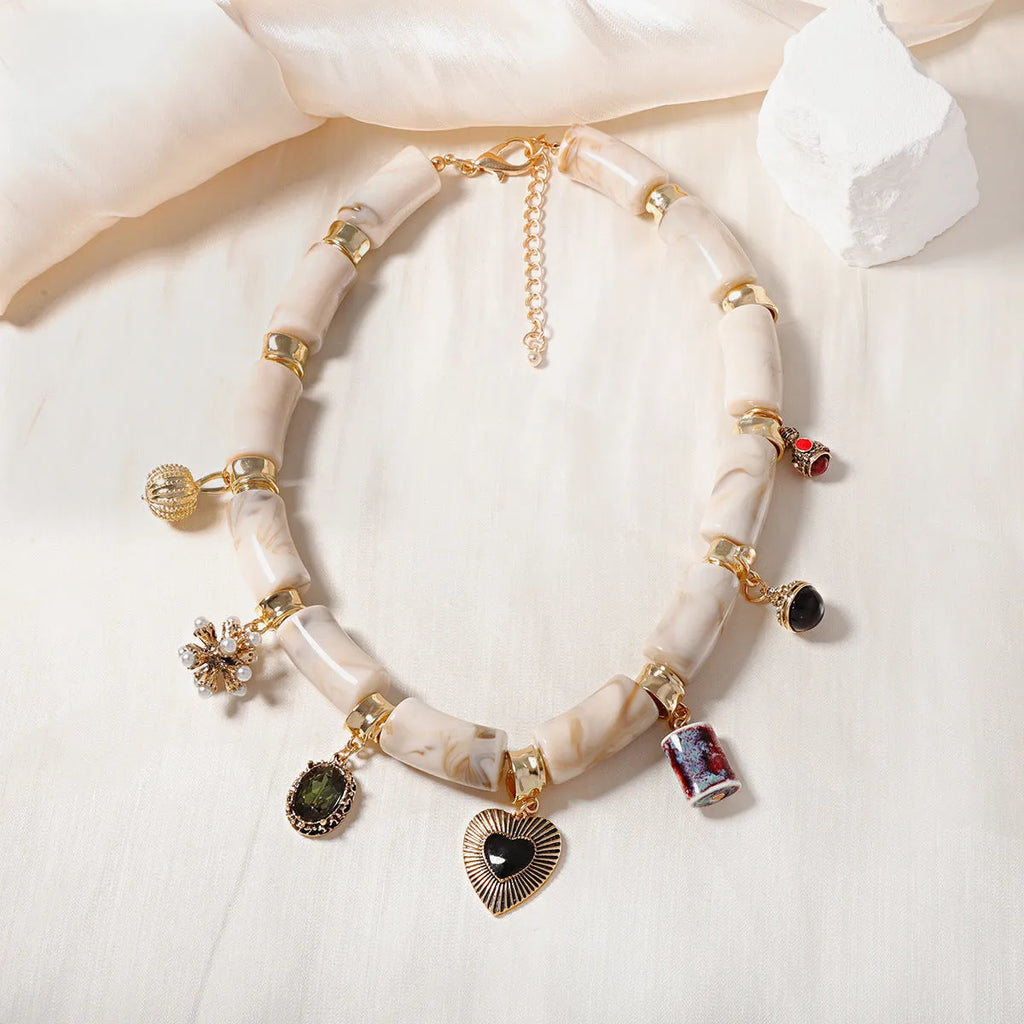 Electroplated resin bamboo heart pendant necklace with chain on white background