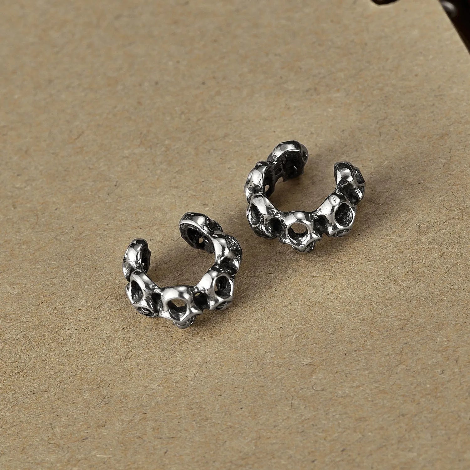 Stainless steel hollow skull earrings with electroplated finish and geometric design