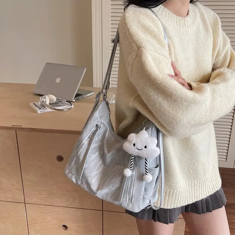 Women's soft PU fashion backpack with pendant accessory in beige, black, blue, and silver colour options