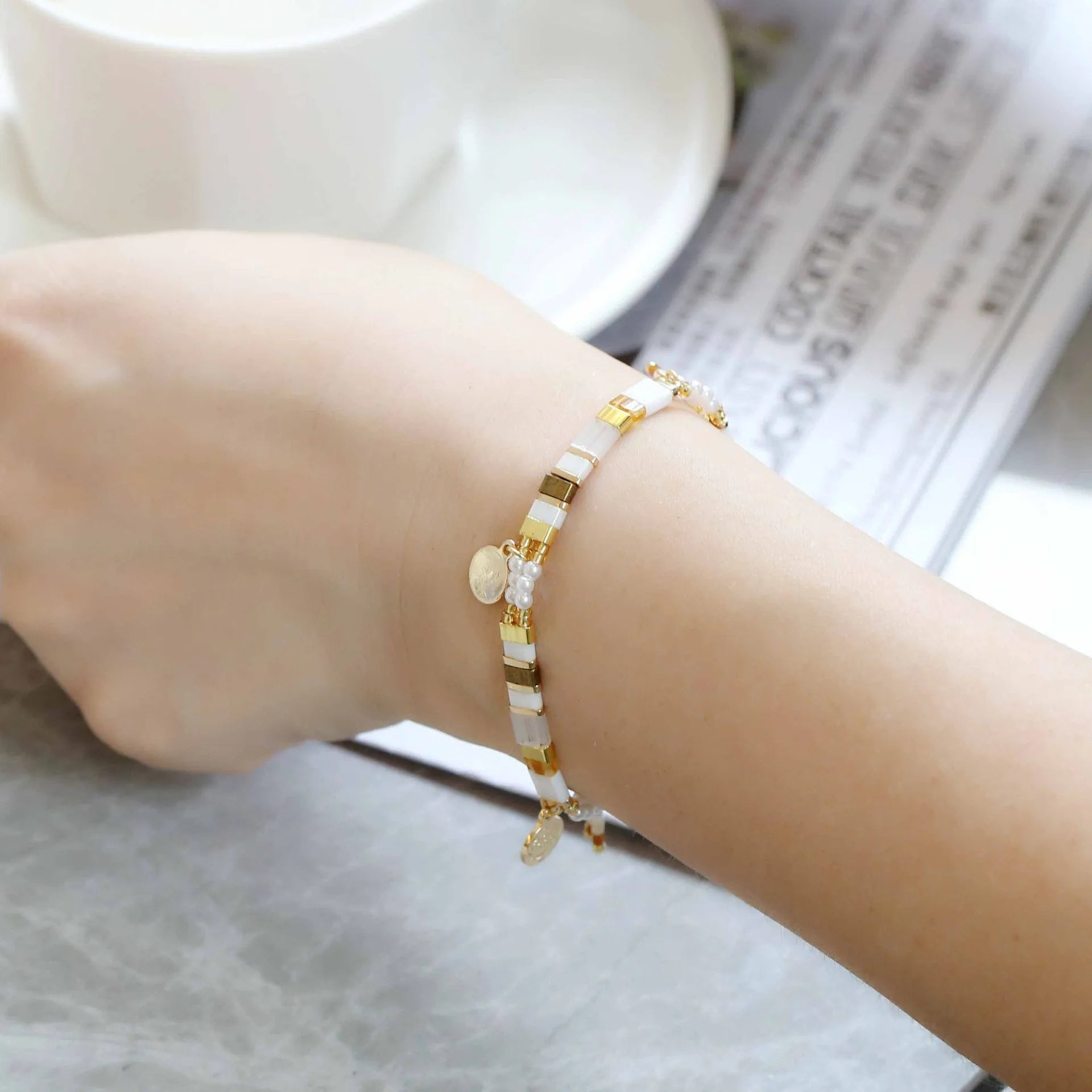 Women's handcrafted imitation pearl bracelet shown in one of six available colour variations.
