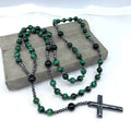 Men's stone necklace with a geometric cross pendant on a ball bead chain, showing the safety lock clasp.